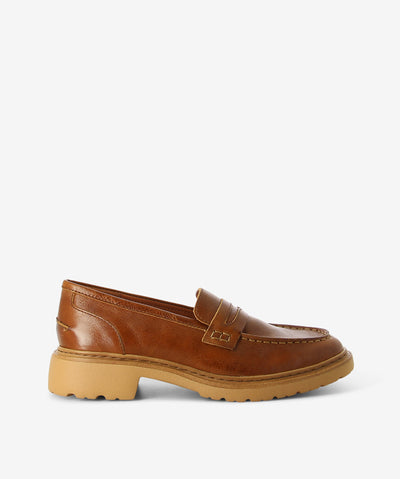 Tan leather loafers by Django & Juliette. It is a slip on style that features a contrasting midsole and a round toe.
