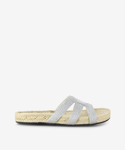 Silver metallic espadrille sandals by 2 Baia Vista. It is a slip-on style and features a metallic woven upper, espadrille sole, and a round toe.