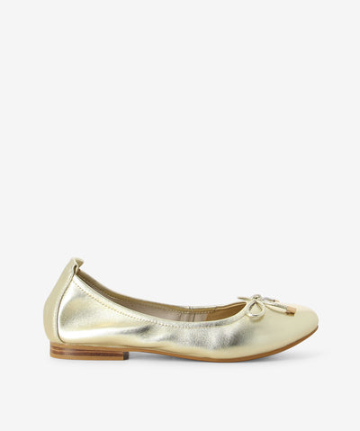 Platinum metallic leather flats by 2 Baia Vista. It is a slip on style and features a bow embellishment on the toe, low block heel, and a round toe.