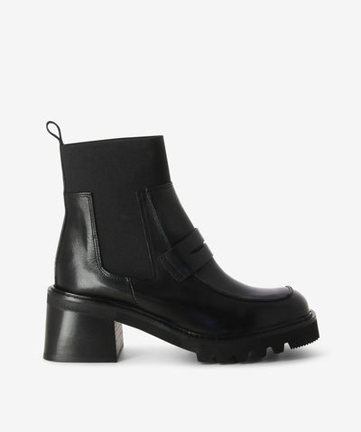 A black leather Chelsea boots with features elastic gussets, elastic cuff, pull tabs, layered heel, strip cut-out upper and a soft square toe.
