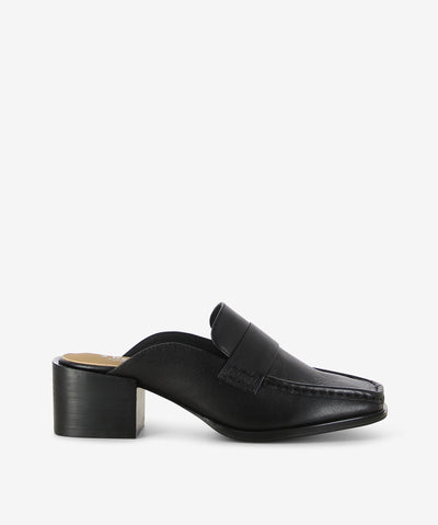 Black leather loafer mules by 2 Baia Vista. It is a slip-on style and features a mid block heel and a square toe.