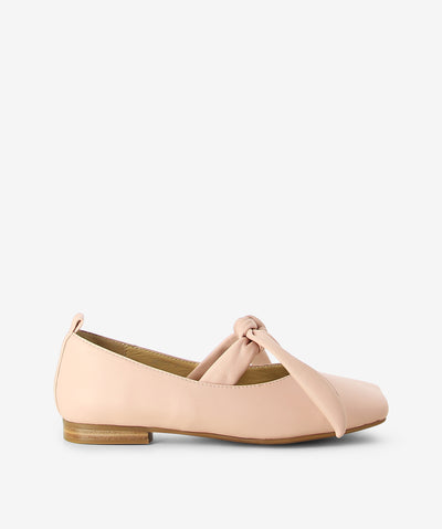 Nude leather flats by 2 Baia Vista. It features soft leather tie-up straps, a low block heel, and a contoured square toe.