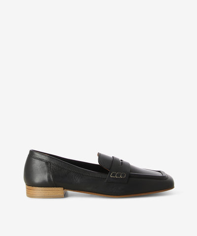 Black leather loafers with a slip-on style and features a low stacked heel with a square toe.
