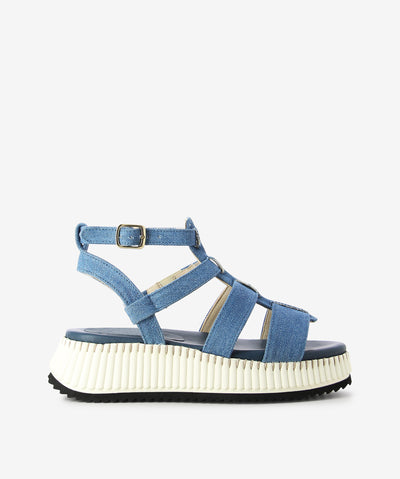 Blue denim platform sandals by Neo. It features an adjustable strap with pin-buckle fixture, platform sole with ribbed midsole, and a round toe.