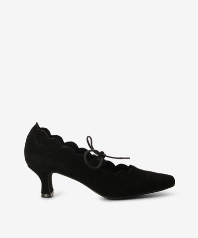 Black suede heels by Django & Juliette. It has scalloped edges, lace up fastening, and an enclosed pointed toe.
