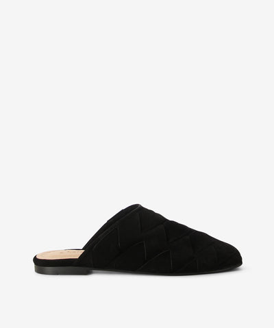 Black suede mules by 2 Baia Vista. It is a slip-on style with an enclosed upper that features super soft interwoven suede as its upper, a flat sole, and a square toe.