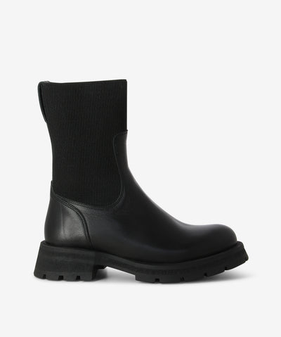 Black leather boots with an elastic sock insert and features a chunky tread sole and a round toe.