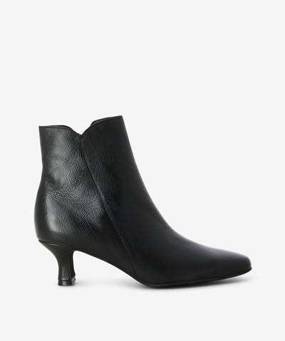 Black leather heeled boots by Django & Juliette. It features a side zip closure, kitten heel, and a pointed toe.