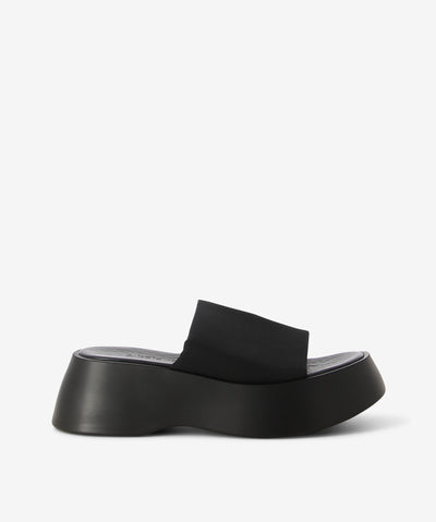Black platform mules by 2 Baia Vista. It has a fabric and features a double-lined fabric upper and a squared toe.