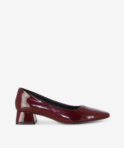 Polished and versatile, the Court heels by Martini Marco are your go-to for timeless sophistication. Crafted in glossy wine patent leather, this style is defined by its sleek square toe and a modern mid-block heel for comfort that lasts all day. From office hours to after-dark occasions, the Court is an effortless staple that elevates every outfit with understated elegance.