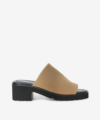 The legend is back! The Daj slides by 2 Baia Vista return in sleek Tan textile with a wide vamp, sturdy block heel, and chunky tread sole for a fresh, contemporary edge.
Crafted with breathable mesh stretch fabric, lambskin leather lining, and a feather-light Air EVA outsole, they deliver all-day comfort and effortless style—perfect for both relaxed tailoring and off-duty looks.