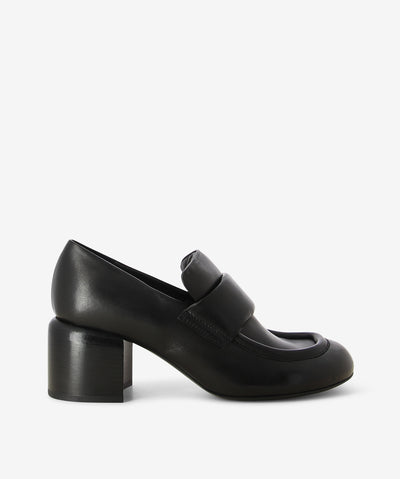 Black leather heeled loafer by Officine Creative. It has a soft padded tongue, block heel, and rounded toe.