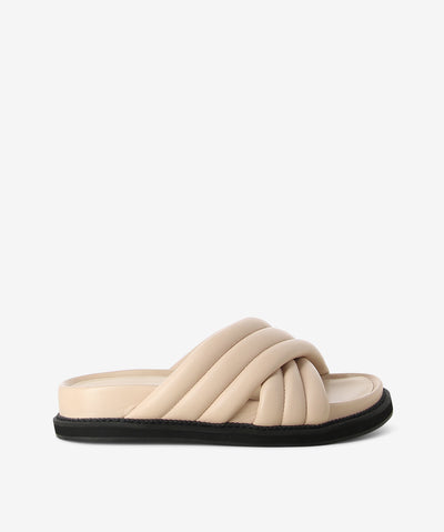 Off-white leather cushion slides by AJ Projects. It is a slip-on style and features crossover straps, a moulded footbed and a round toe. 