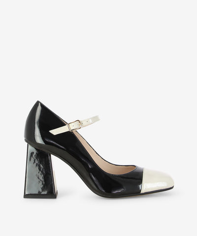 Black and off white patent leather Mary-Janes by Lodi Love. It features a contrasting off white toe detail and strap with a pin-buckle fixture, block heel, and a square toe.