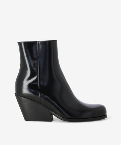 Black patent leather boots by Beau Coops. It features a side zip closure, Cuban heel, and a round toe.