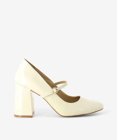 White patent leather Mary Jane heels by Siren. It features a block heel, adjustable pin-buckle strap, and a round toe.