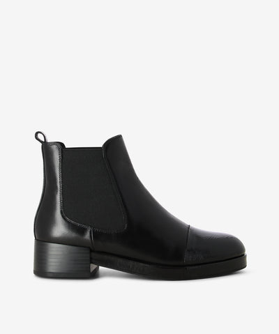 Black leather Chelsea boots by Elvio Zanon. It has a round patent toe, elastic gussets, and a rear pull tab.