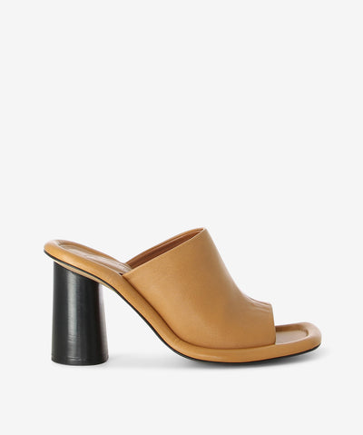 Camel leather heels by ZOMP. It is a slip-on style and features a cushioned outsole, cylindrical heel and a soft square toe. 