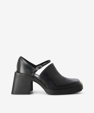 Black leather mary-janes by Justine Clenquet. It has an adjusted pin-buckle strap across the instep and features a chunky block heel and a square toe.