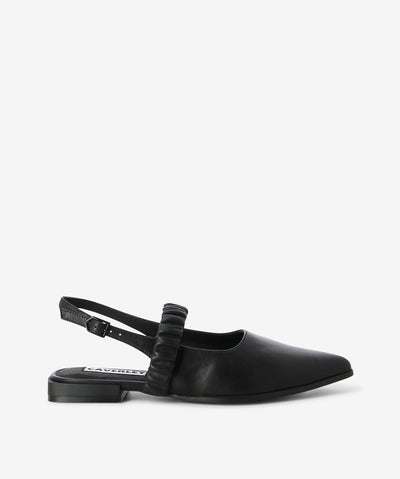 Black leather flats by Caverley. It features a slingback strap with an adjustable pin-buckle fixture, cross-foot elasticated strap, and a pointed toe.