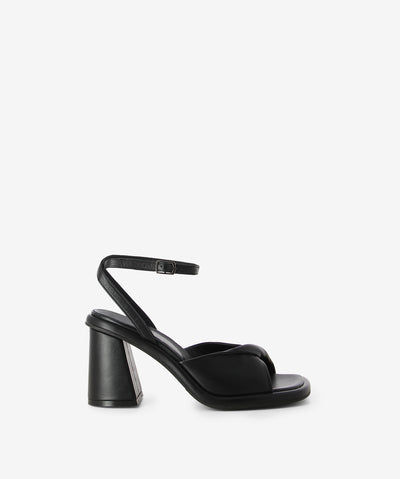 Black leather sandals by Epoche Xi. It has an adjusted sling back pin-buckle strap and features a block heel and a soft square toe.