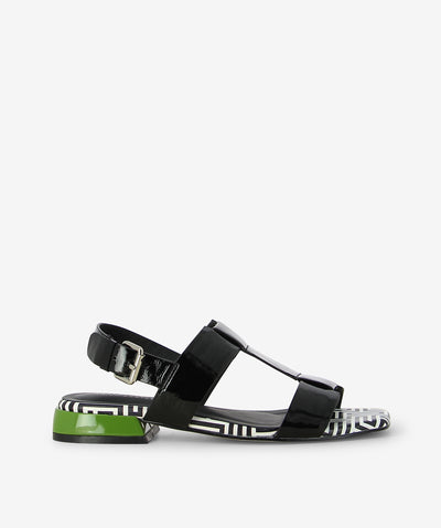Step up your everyday style with the Santos Black Patent Sandal—a daring mix of sleek sophistication and playful detail. Crafted in vibrant black patent leather, it features two wide top straps and a slim ankle strap with a metallic buckle for a secure, adjustable fit. The modern square toe adds a contemporary edge, while the standout sole presents a bold black-and-white geometric pattern and a vivid green heel accent for an unexpected pop of colour.