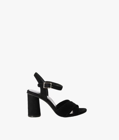 Black suede leather sandals by Martini Marco. It has an ankle buckle strap with a features round block heel and a round toe.