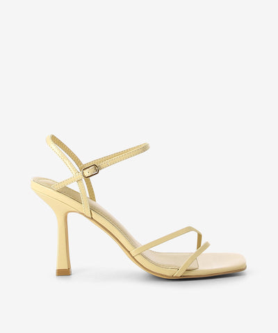 Nude patent heels by Siren. It features strappy upper, ankle strap with pin-buckle fastening, and a square toe.
