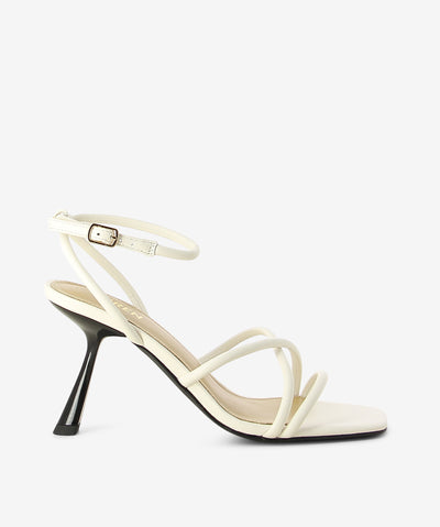 Off white leather heeled sandals by Siren. It has an ankle buckle fastening and features crossed strappy upper, slated heel and an open square toe.