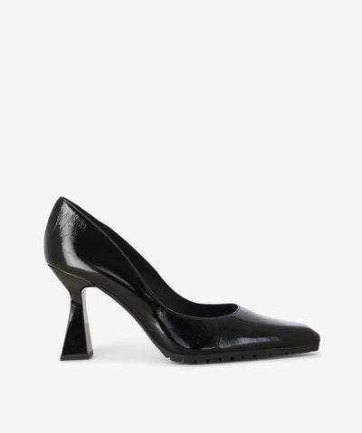 Black patent leather pumps by Lodi. It is a slip on style and features a tapered component heel, rubber tread sole, and a pointed toe.