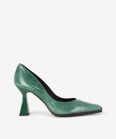 Green patent leather pumps by Lodi. It is a slip on style and features a tapered component heel, rubber tread sole, and a pointed toe.