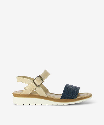 Step into effortless summer style with the Trieste sandal by Origini Studio. Crafted in a chic beige and-navy palette, this sandal combines comfort and natural texture with a modern edge. The design features a smooth beige leather ankle strap with an adjustable buckle for a secure fit, while the woven front strap adds a touch of artisanal charm. Finished with a rounded toe, cushioned insole, and lightweight sole, the Trieste offers all-day comfort—perfect for strolling through the city or enjoying weekend g