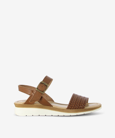 Step into effortless summer style with the Trieste sandal by Origini Studio. Crafted in a chic cocoa palette, this sandal combines comfort and natural texture with a modern edge. The design features a smooth cocoa leather ankle strap with an adjustable buckle for a secure fit, while the woven front strap adds a touch of artisanal charm. Finished with a rounded toe, cushioned insole, and lightweight sole, the Trieste offers all-day comfort—perfect for strolling through the city or enjoying weekend getaways.