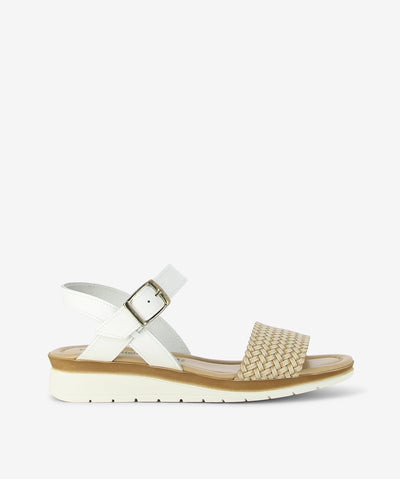 Step into effortless summer style with the Trieste sandal by Origini Studio. Crafted in a chic white-and-beige palette, this sandal combines comfort and natural texture with a modern edge. The design features a smooth white leather ankle strap with an adjustable buckle for a secure fit, while the woven front strap adds a touch of artisanal charm. Finished with a rounded toe, cushioned insole, and lightweight sole, the Trieste offers all-day comfort—perfect for strolling through the city or enjoying weekend 