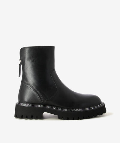 Black leather ankle boots by Caverley. It features a chunky tread sole, rear zip closure, and a round toe.
