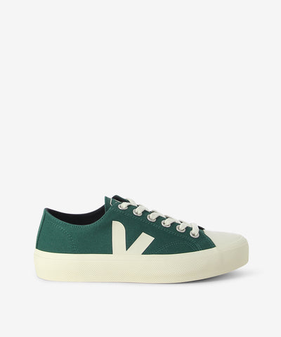 Green canvas sneakers are a lace-up fastening and features a textile upper, a rubber sole and a round toe.