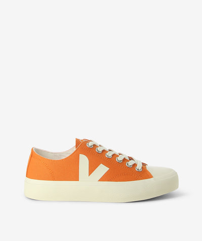 Orange canvas sneakers are a lace-up fastening and features a textile upper, a rubber sole and a round toe.