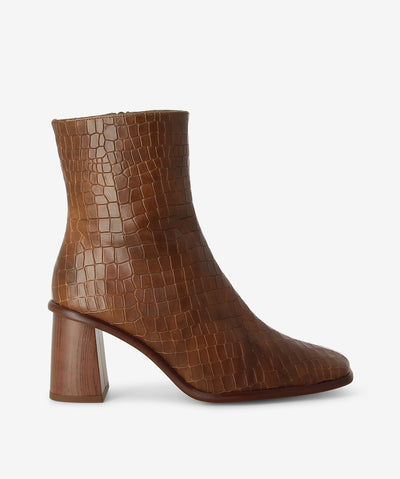 Brown croc embossed leather ankle boots by Alohas. It has an inner zip fastening and features a slim-line silhouette pairs, block heel and a square toe.