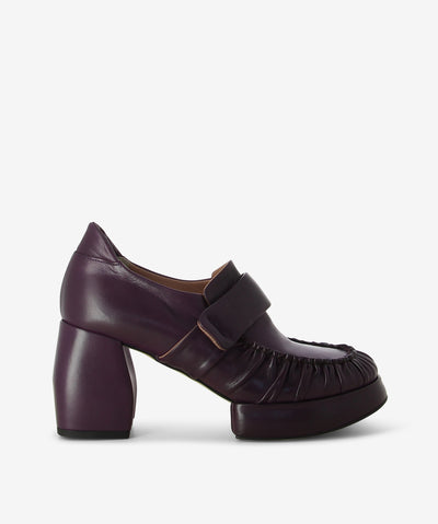 Wine leather heeled loafers with a slip-on style and features ruched leather detailing, a block heel, platform sole and a round toe.