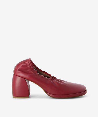 Cherry red leather pumps with a slip-on style and features a ruched elastic collar, block heel and an anatomic square toe.