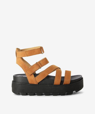 Tan platform leather strappy sandals by Rollie. It has 2 adjustable velcro-fastened straps, chunky tread sole, and a round toe.