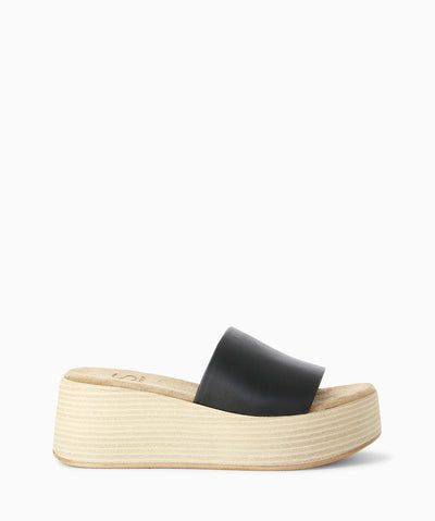 Black leather platform slides with a stacked platform sole, suede insole and a round toe.