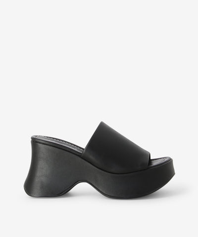 Black platform sandals featuring a chunky curved sole and a round toe by Jeffrey Campbell.