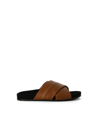 Tan leather slip-on slides that feature crossover straps, a lightly cushioned sole and a soft square toe by L'Artigiano Del Cuoio.