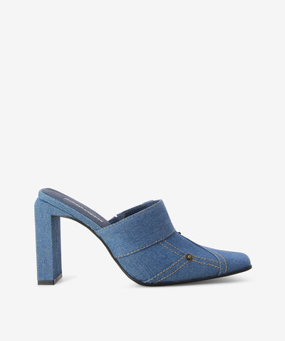 Blue denim closed mules with trompe-l'œil denim detailing, a slender heel and a square toe by Jeffrey Campbell.