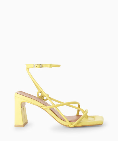 Yellow leather heels with a wrap-around ankle strap with buckle fastening and featuring a strappy upper, slender heel, toe post and a square toe.