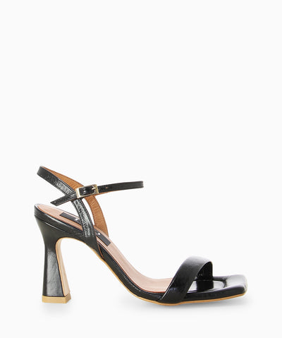 Black leather heels with a high shine finish, slender heel and a square toe.