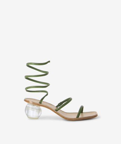 Green leather sandals with a spiral ankle wrap fastening and featuring a transparent orb heel and a soft square toe.