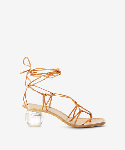 Metallic orange leather sandals with an ankle tie fastening and featuring a strappy upper, transparent orb heel and a soft square toe.