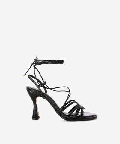 Black leather heels with an ankle tie fastening and featuring braided detailing, an hourglass heel and a round toe.
